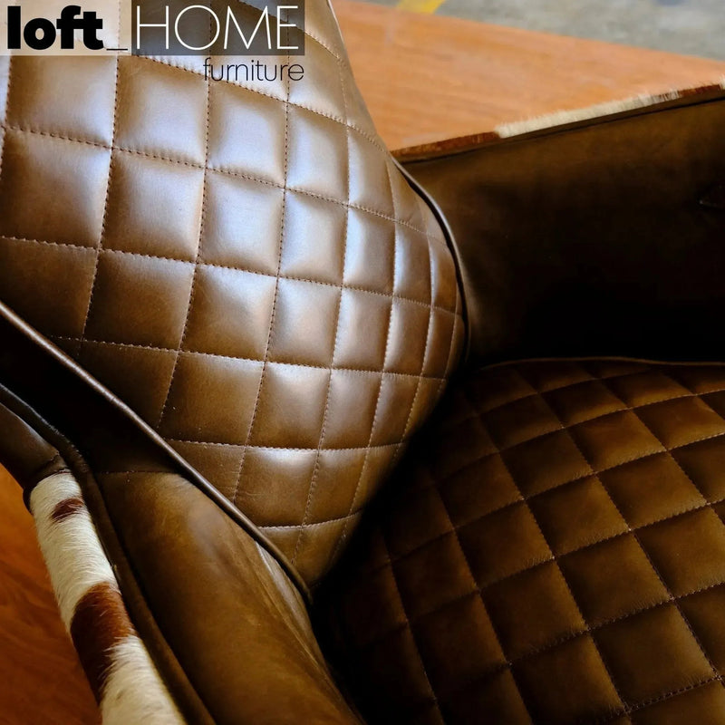 Vintage cowhair genuine leather 1 seater sofa moo in still life.