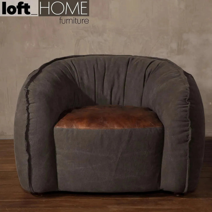 Vintage fabric and genuine leather 1 seater sofa bread in close up details.