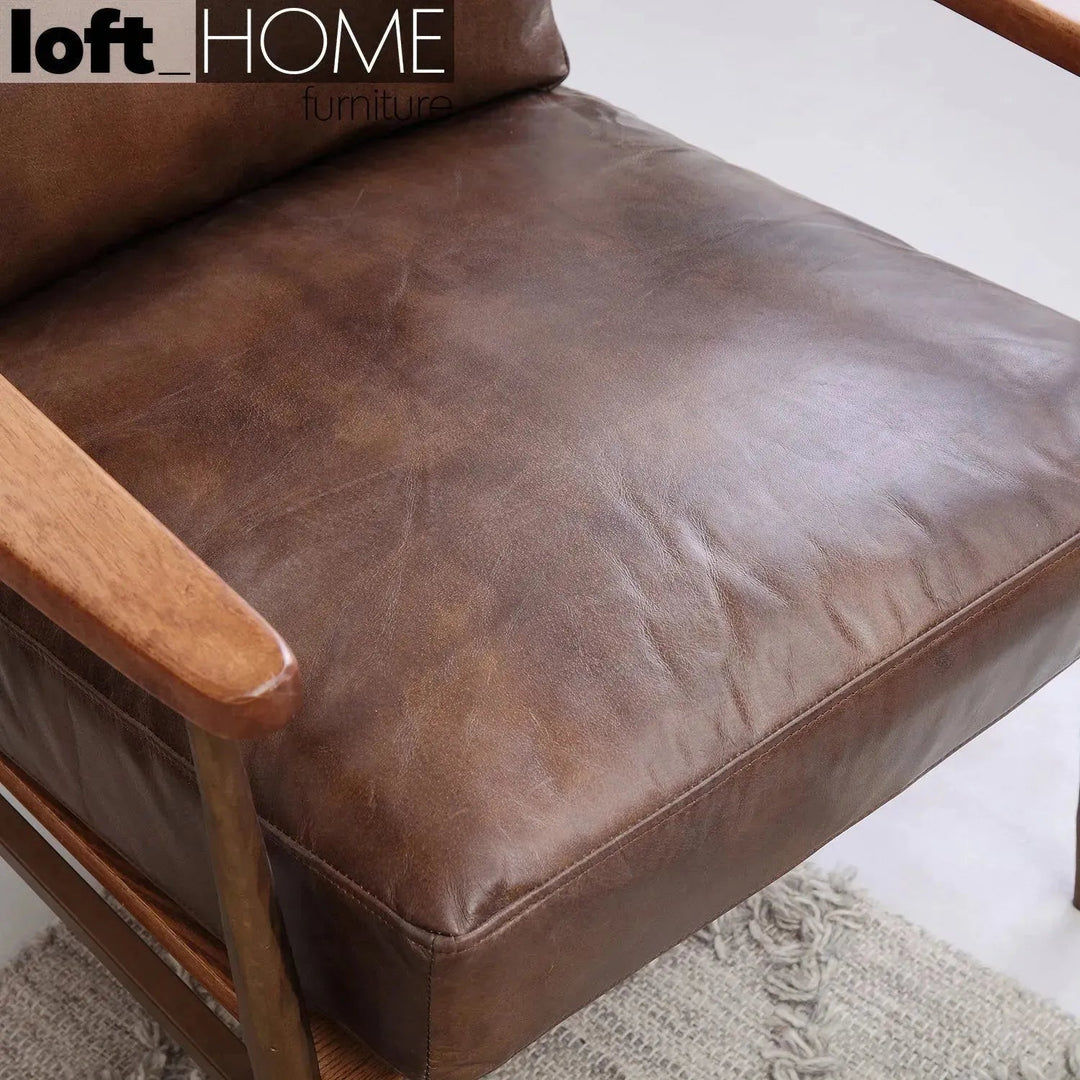 Vintage genuine leather 1 seater sofa hummer brass in close up details.