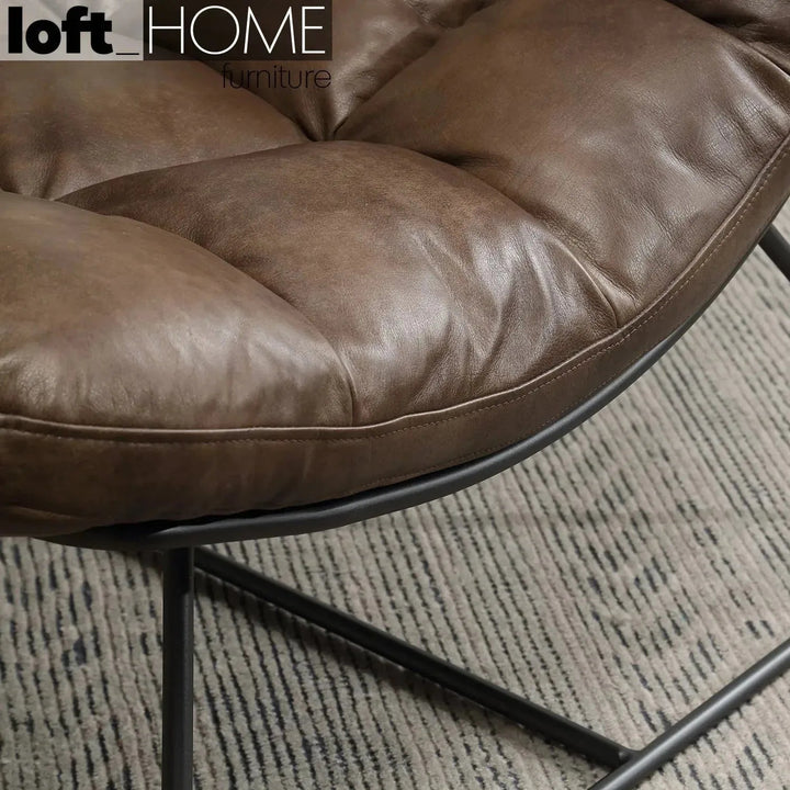 Vintage genuine leather 1 seater sofa sand in close up details.