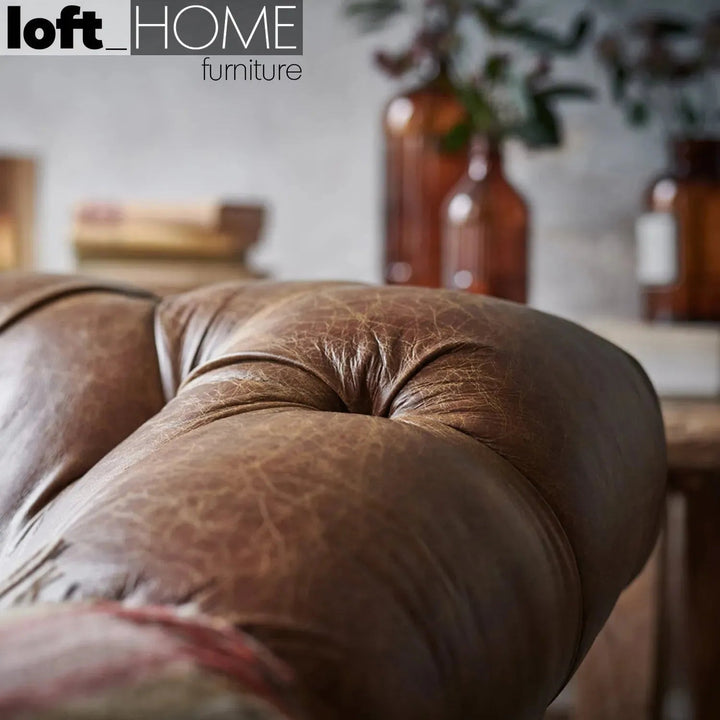 Vintage genuine leather 2 seater sofa chesterfield button in details.