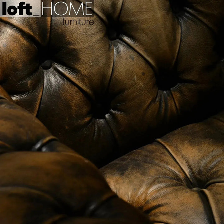 Vintage genuine leather 2 seater sofa chesterfield button in panoramic view.