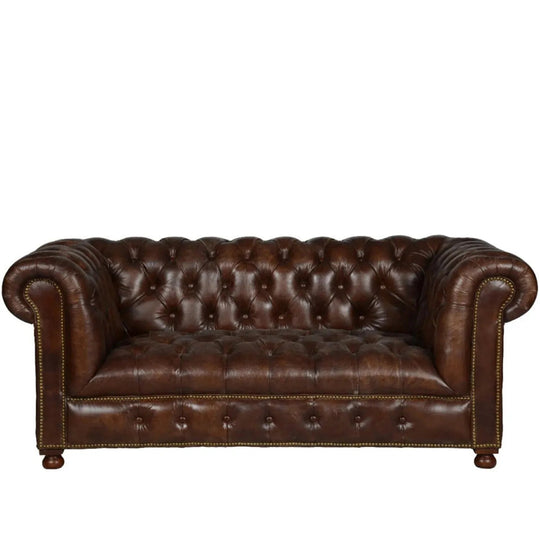 Vintage genuine leather 2 seater sofa chesterfield button in white background.