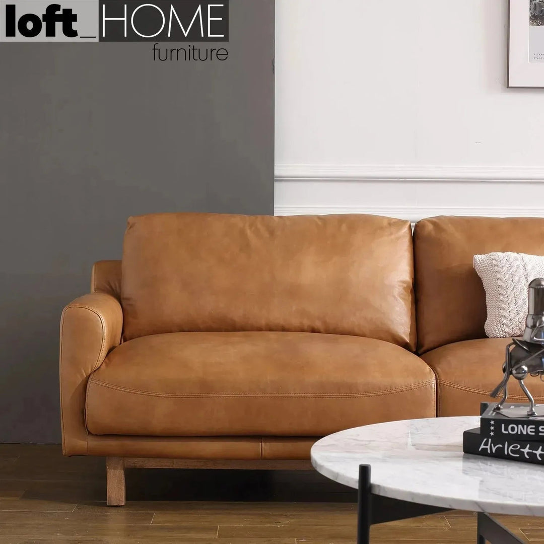 Vintage genuine leather 3 seater sofa rw and nut ter in panoramic view.