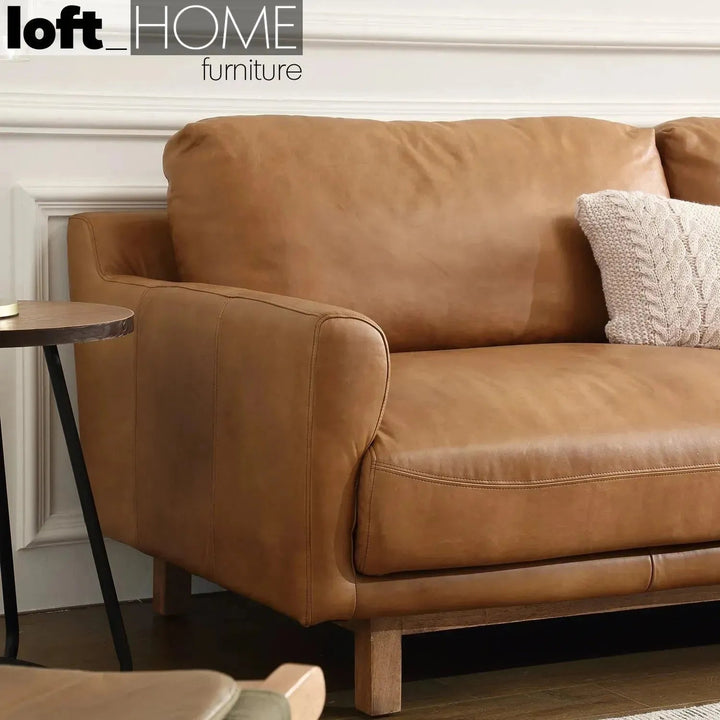 Vintage genuine leather 3 seater sofa rw and nut ter in close up details.