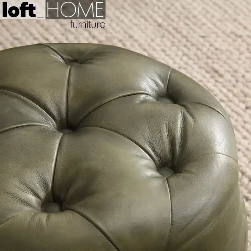 Vintage genuine leather ottoman green franco in close up details.