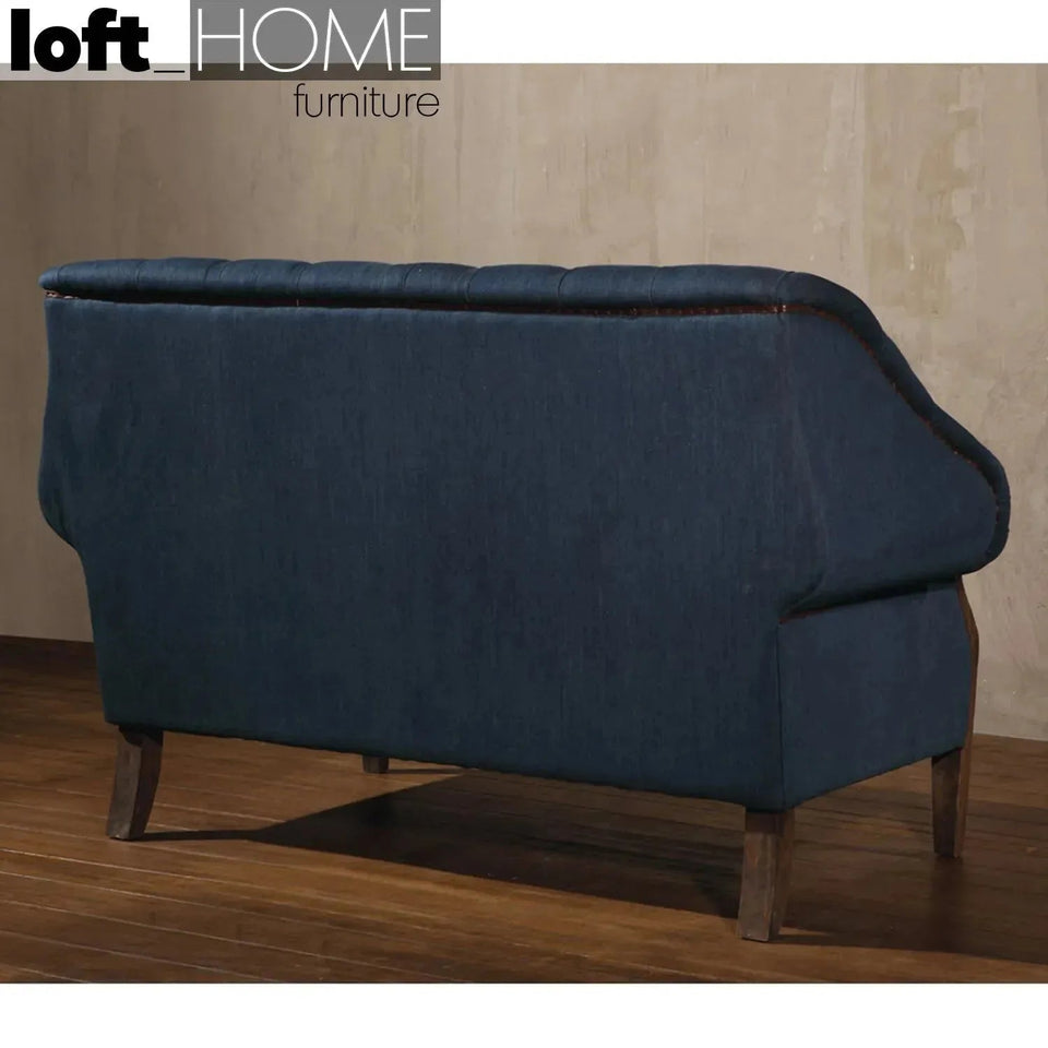 Vintage jeans fabric and genuine leather 2 seater sofa cowboy in close up details.