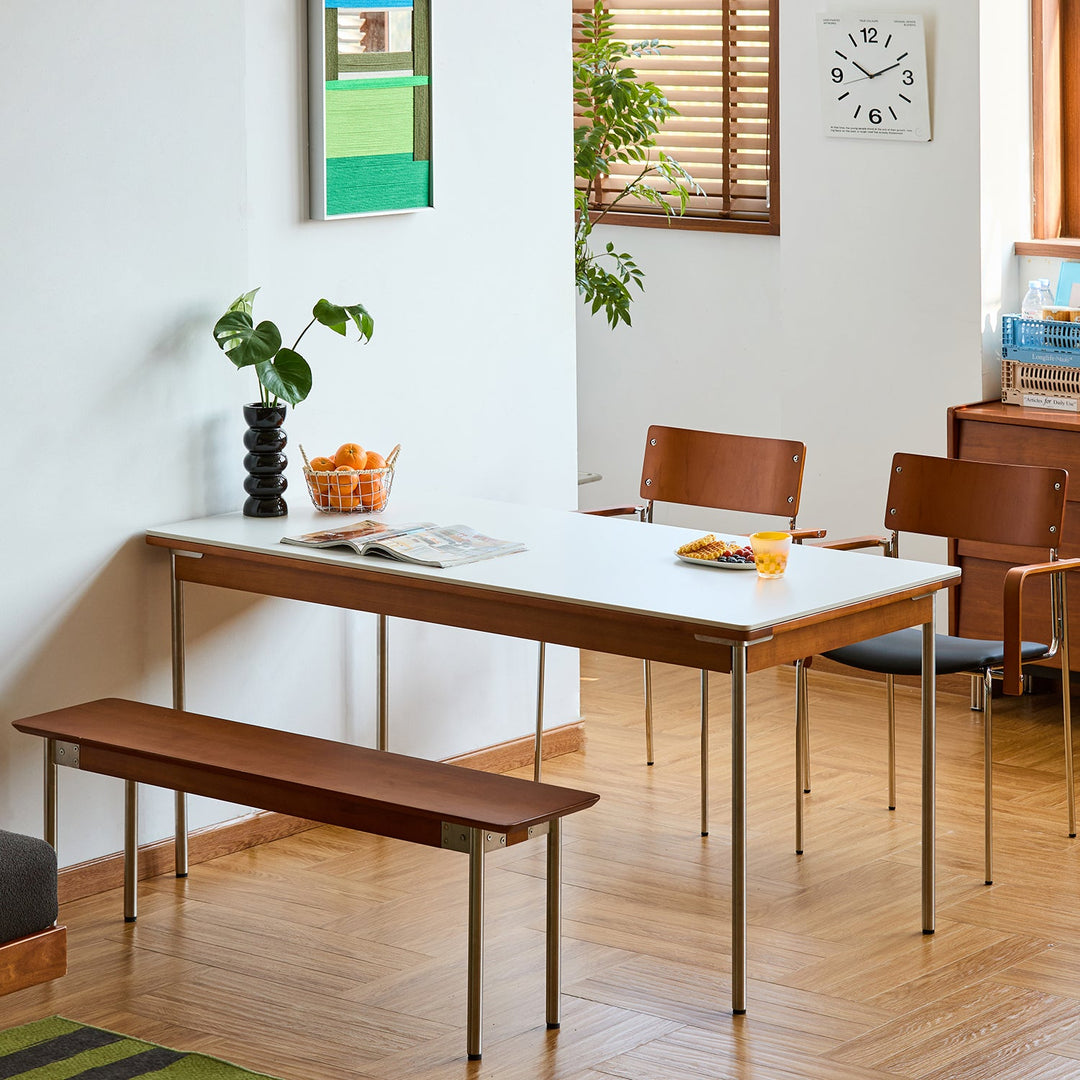 Bauhaus sintered stone boxwood dining table pinecone in still life.