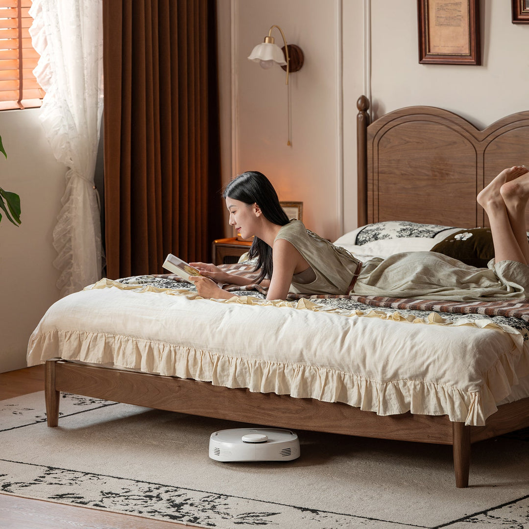 Vintage walnut wood bed midsummer in close up details.