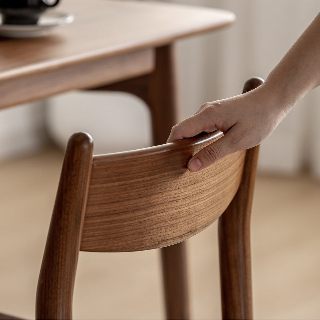 Vintage walnut wood dining chair chrono in close up details.