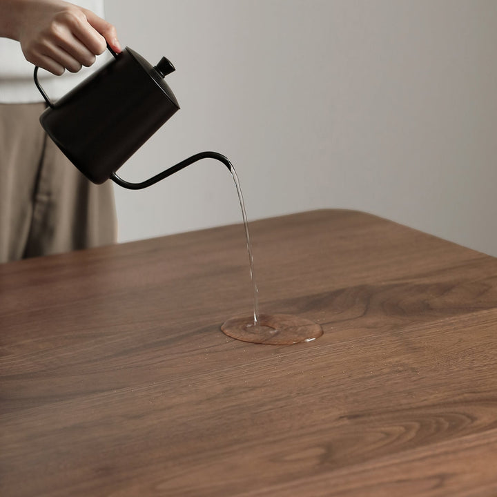 Vintage walnut wood dining table savor in close up details.