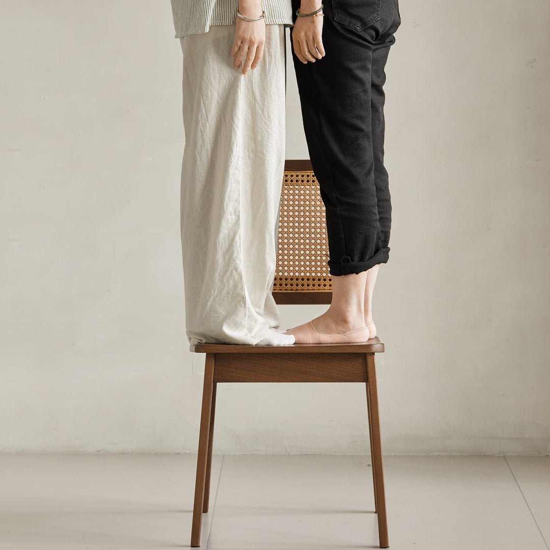 Vintage walnut wood rattan dining chair nook in panoramic view.