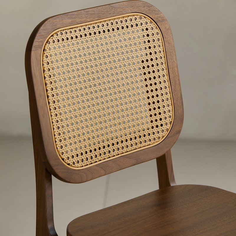 Vintage walnut wood rattan dining chair nook in still life.