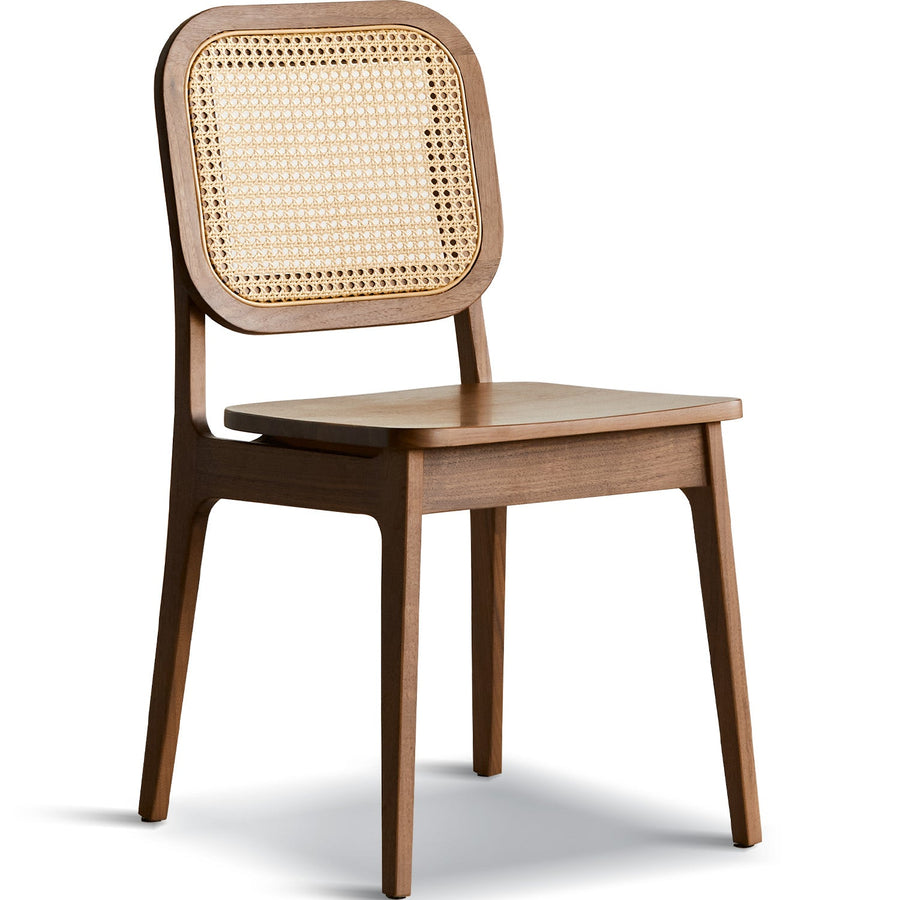 Vintage walnut wood rattan dining chair nook in white background.