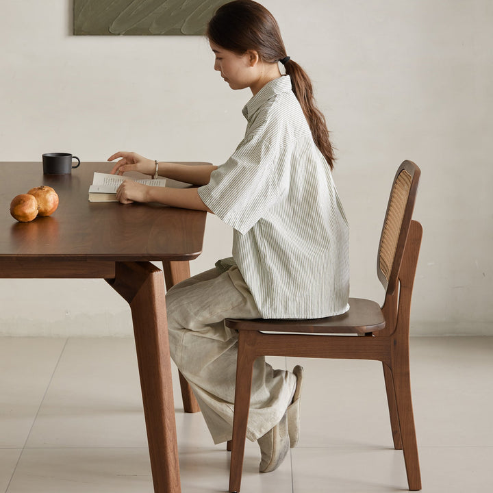 Vintage walnut wood rattan dining chair nook with context.