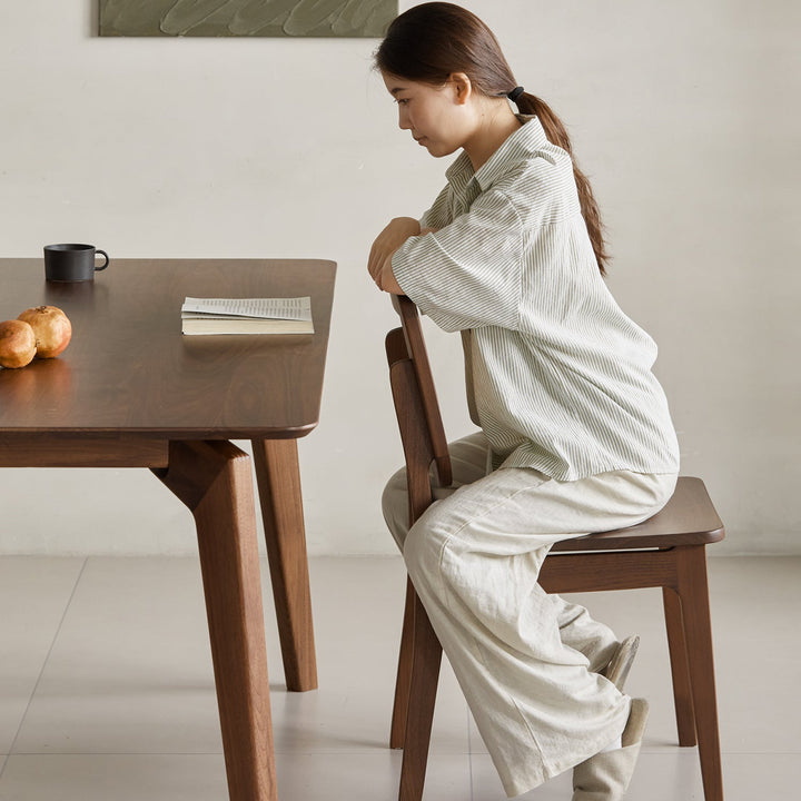 Vintage walnut wood rattan dining chair nook in details.