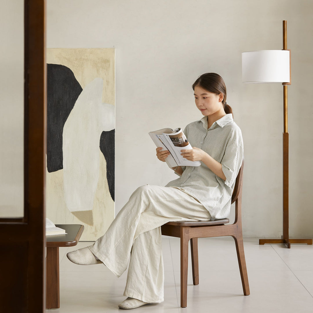 Vintage walnut wood rattan dining chair nook in close up details.